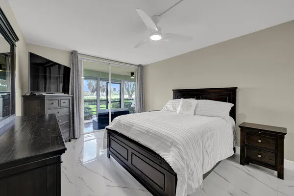 a bedroom with a bed and a flat tv screen