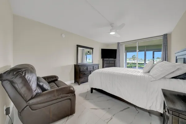 a bedroom with a bed couch and window