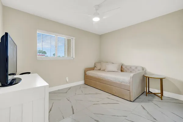 a room with a bed and a flat screen tv