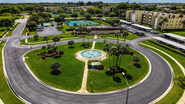 an aerial view of a pool patio fire pit and outdoor seating