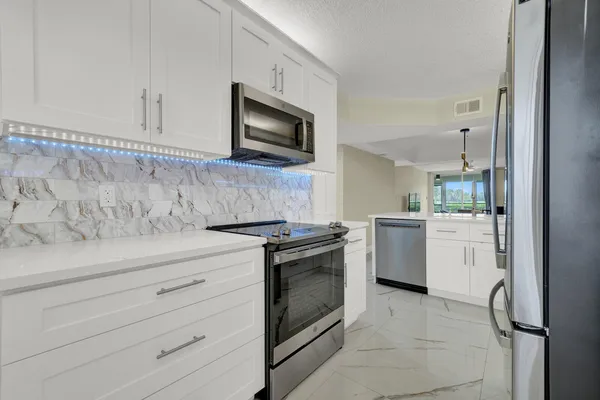 a kitchen with a stove oven and sink