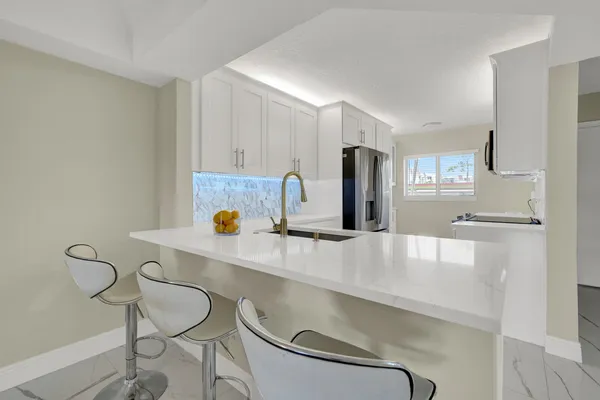 a kitchen with stainless steel appliances a sink and a refrigerator