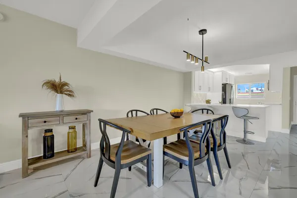 a view of a dining room that has a table and chairs