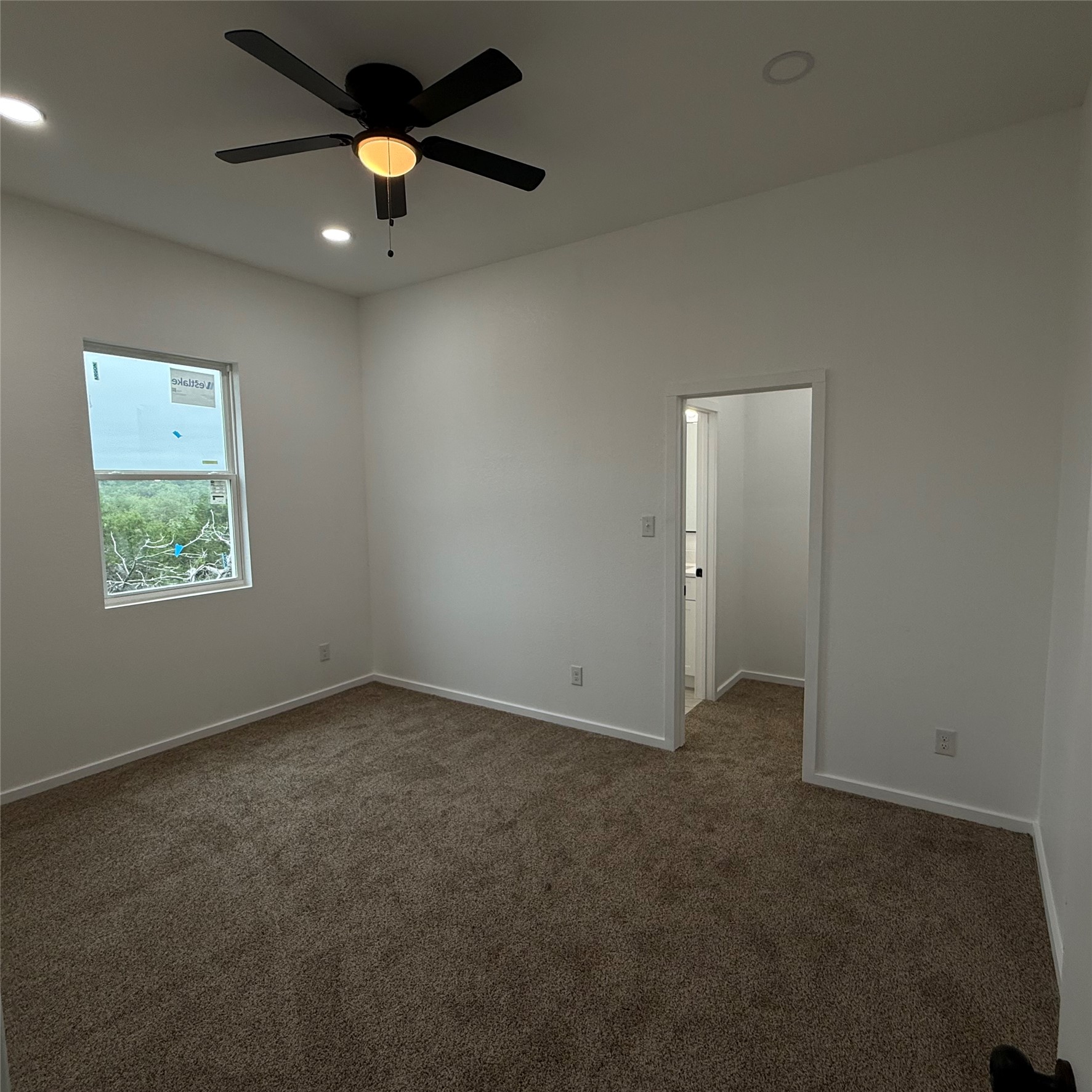 118 Crazy Cross Road Wimberley, TX 78676 - Photo 15 of 18 an empty room with ceiling fan and window