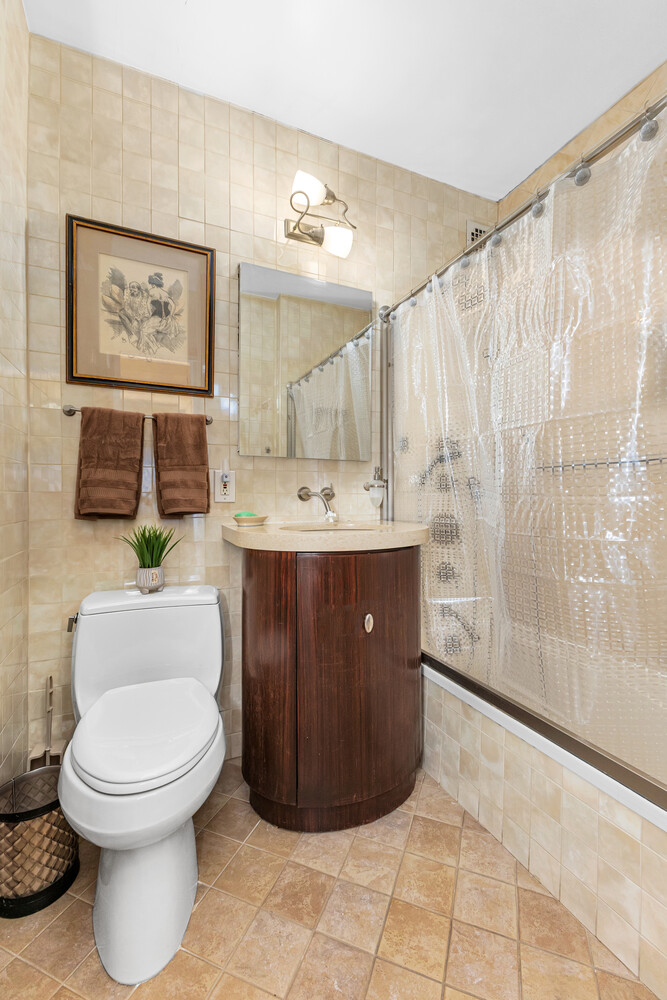 300 East 74th Street, Unit 3CC Manhattan, NY 10021 - Photo 8 of 13 a bathroom with a sink a toilet and a shower