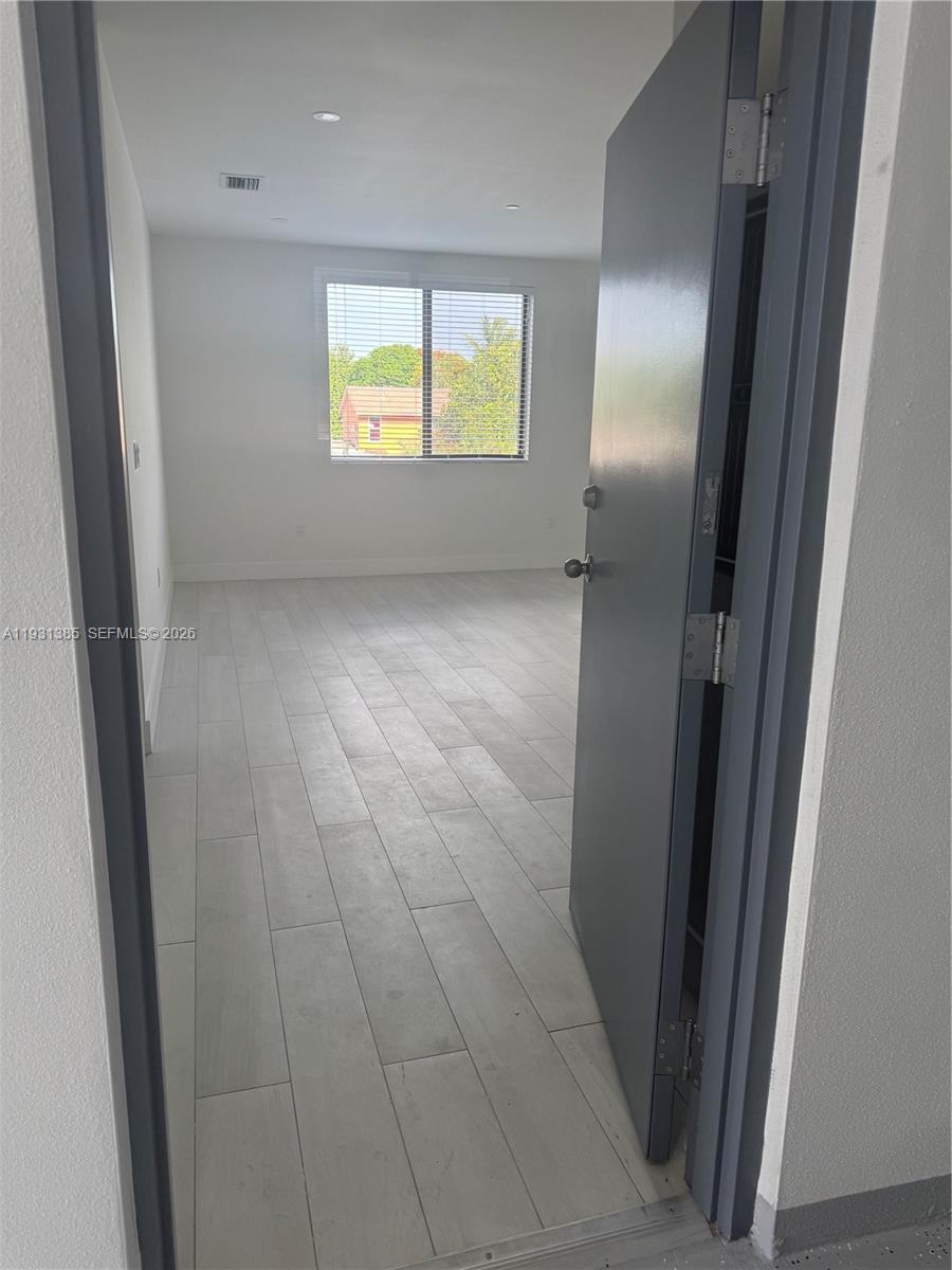 a view of an empty room and window