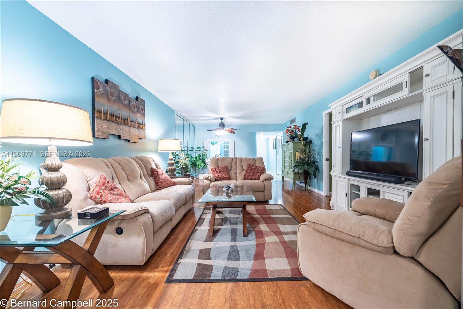 3910 Inverrary Boulevard, Unit 406B Lauderhill, FL 33319 - Photo 11 of 22 a living room with furniture and a flat screen tv