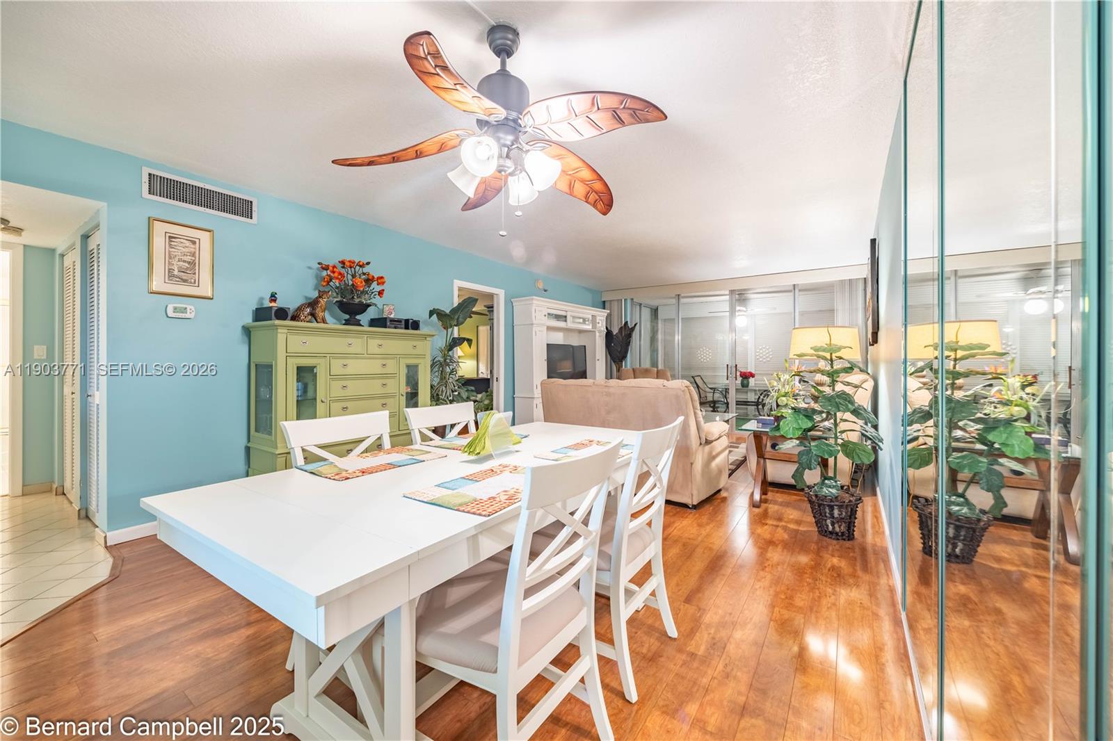 3910 Inverrary Boulevard, Unit 406B Lauderhill, FL 33319 - Photo 14 of 22 a view of a dining room with furniture a chandelier and wooden floor