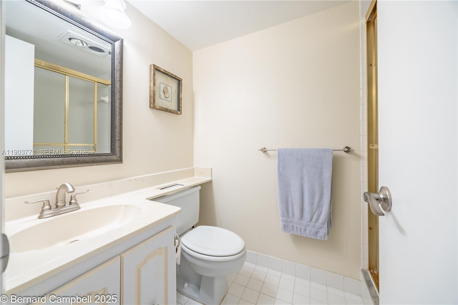 3910 Inverrary Boulevard, Unit 406B Lauderhill, FL 33319 - Photo 16 of 22 a bathroom with a sink toilet and vanity
