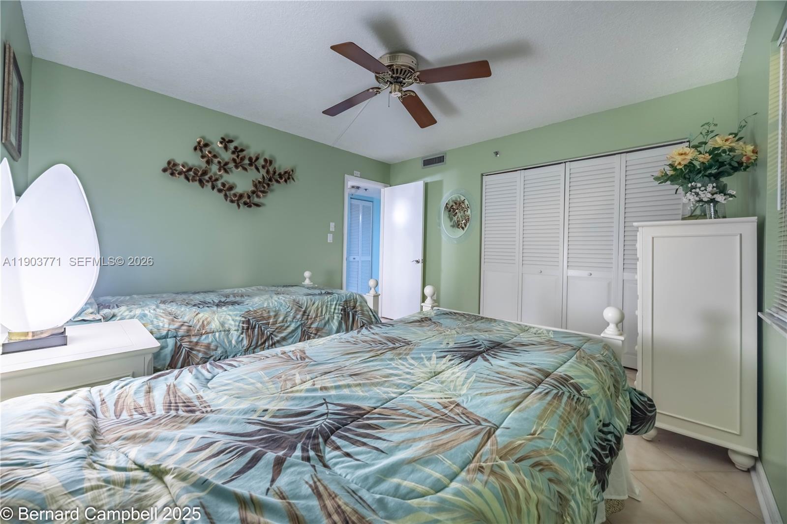 3910 Inverrary Boulevard, Unit 406B Lauderhill, FL 33319 - Photo 6 of 22 a bedroom with a large bed mirror and a window