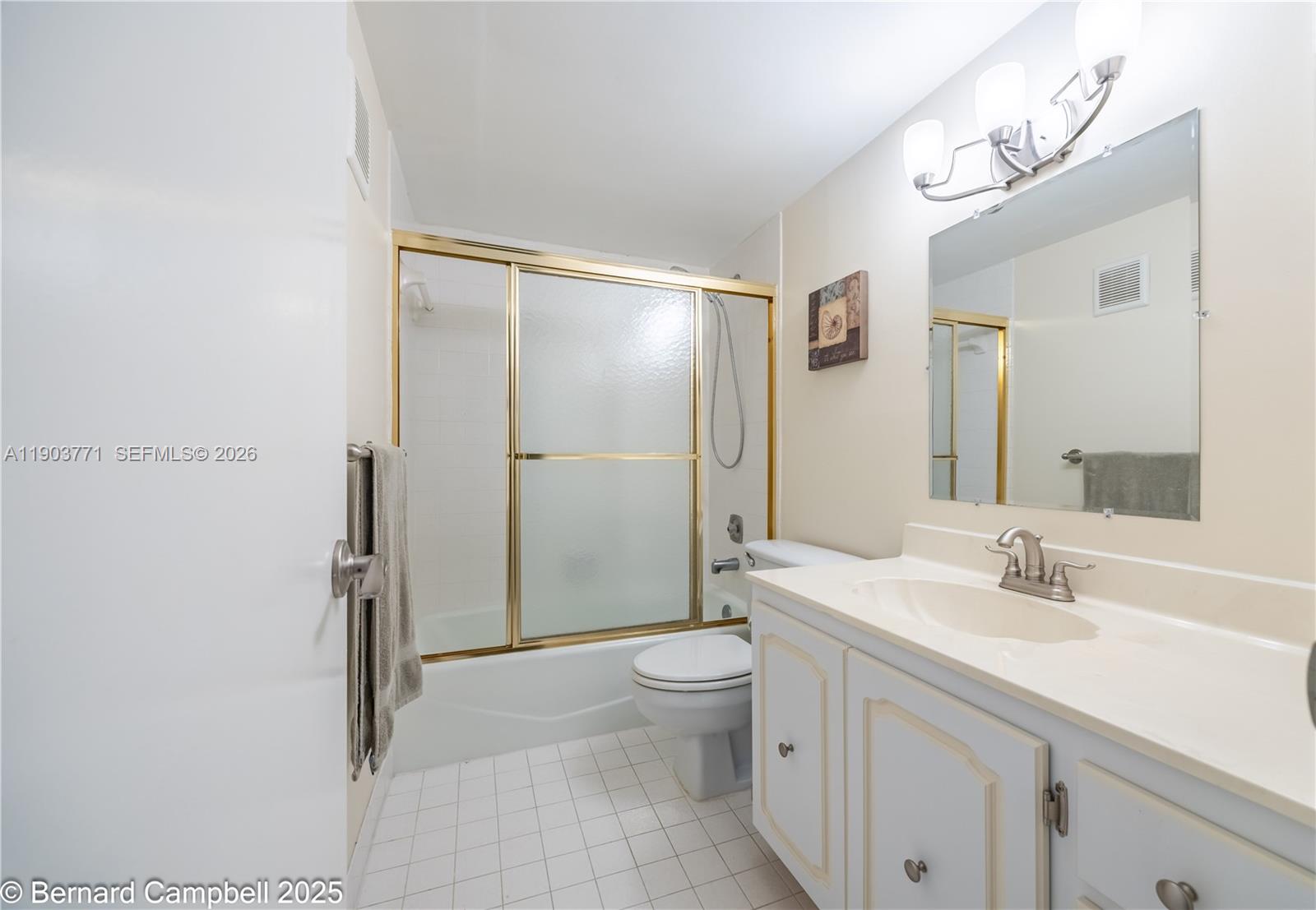 3910 Inverrary Boulevard, Unit 406B Lauderhill, FL 33319 - Photo 7 of 22 a bathroom with a sink a toilet and shower