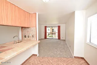 a view of a kitchen with a sink and a window