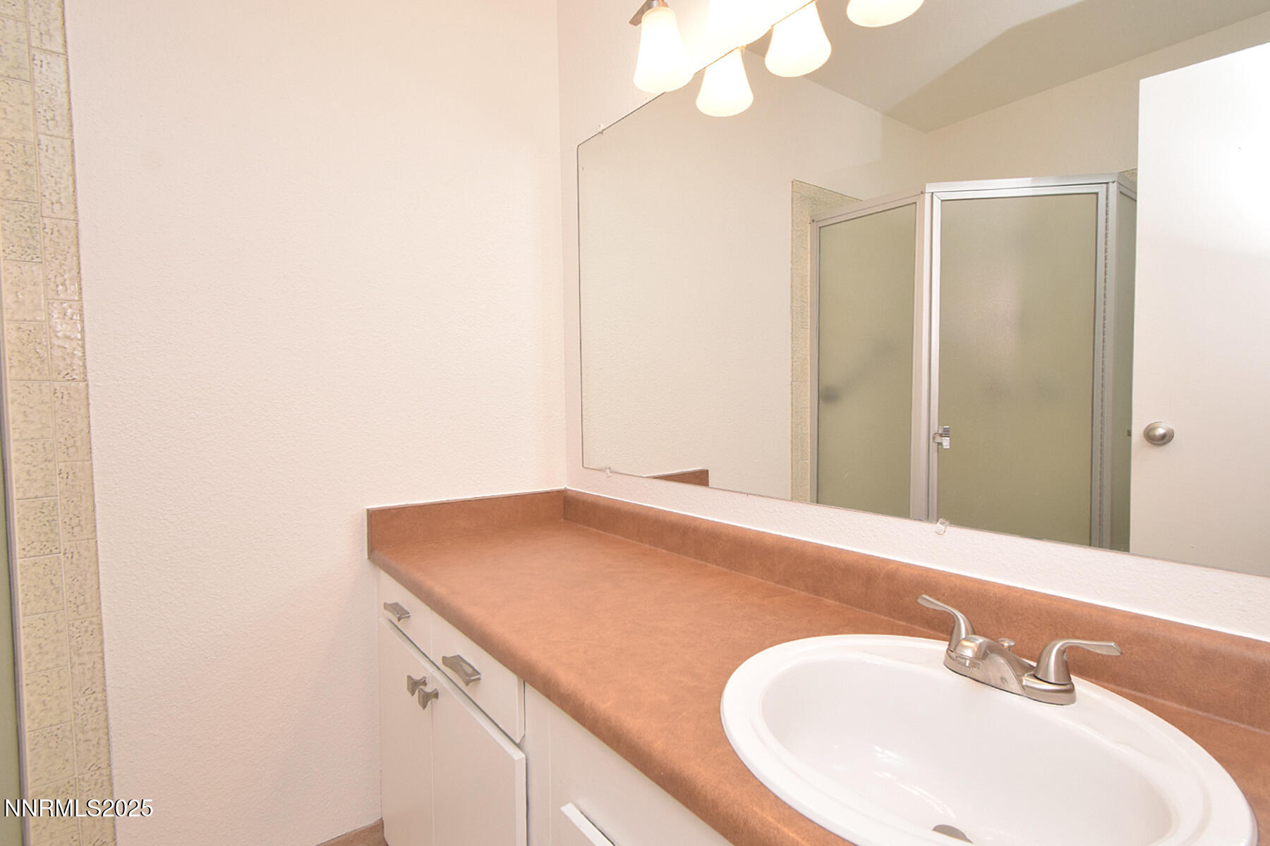 2750 Plumas Street, Unit 201 Reno, NV 89509 - Photo 29 of 34 a bathroom with a sink and a mirror
