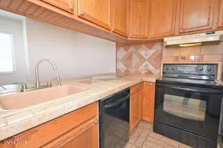 a kitchen with granite countertop stainless steel appliances and wooden cabinets