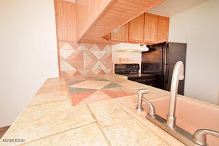 2750 Plumas Street, Unit 201 Reno, NV 89509 - Photo 10 of 34 a kitchen with stainless steel appliances kitchen island granite countertop a refrigerator a stove and a sink with granite countertops