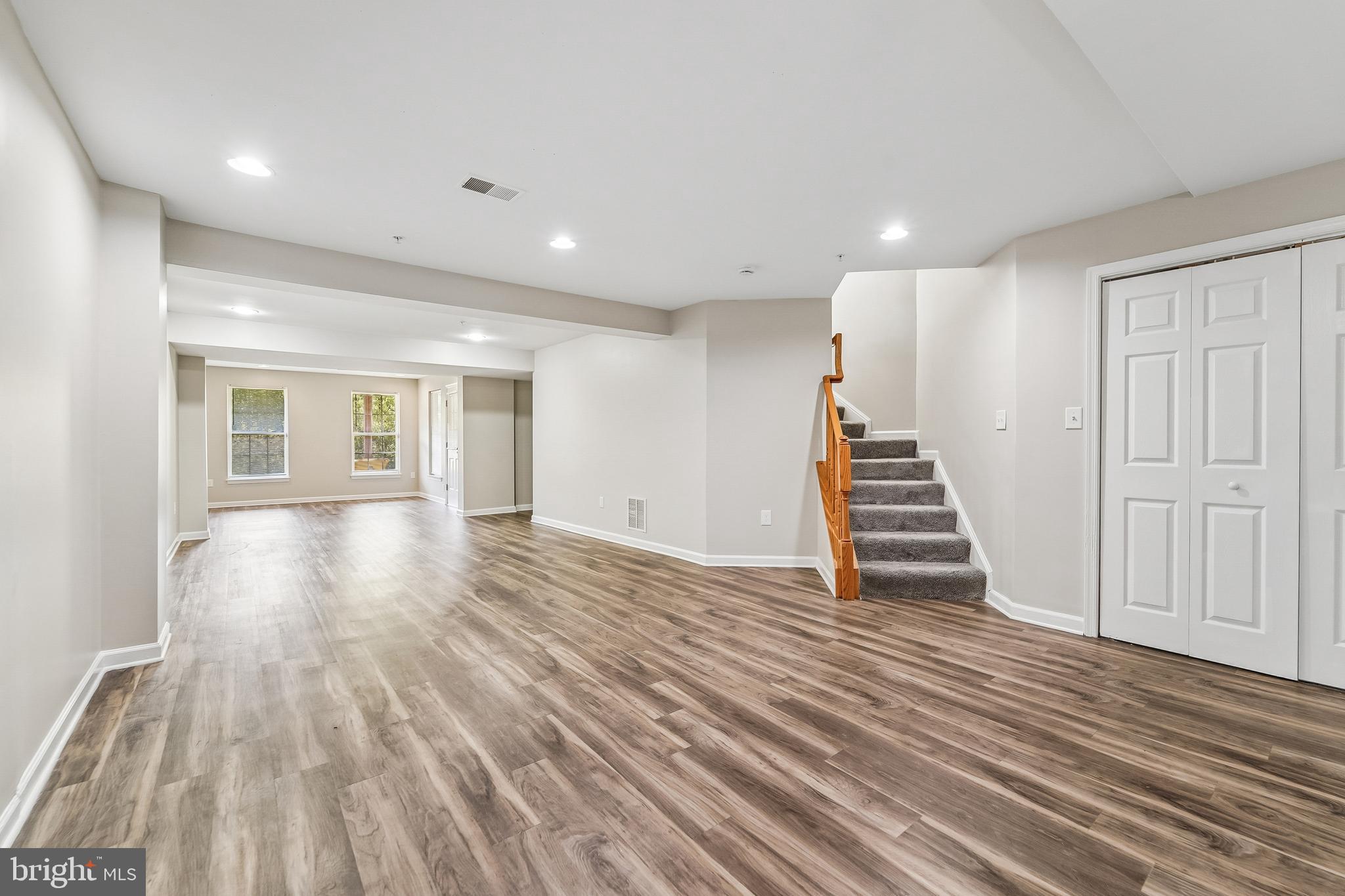 1461 Pangbourne Way Hanover, MD 21076 - Photo 33 of 51 a view of an empty room with wooden floor and stairs