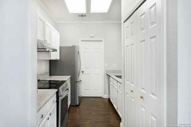 a kitchen with stainless steel appliances a refrigerator and a stove