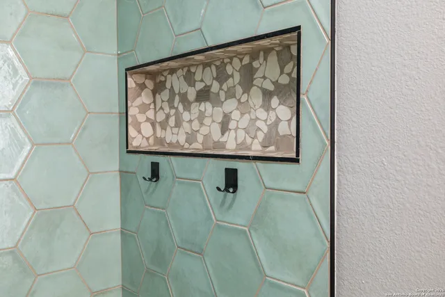 a bathroom with a shower and a sink