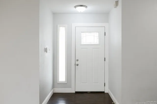 an empty room with wooden floor
