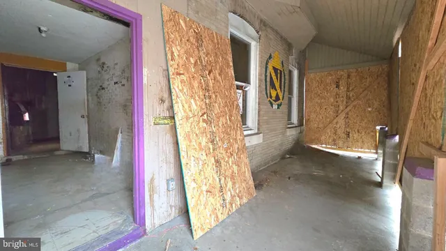 a view of a hallway with wooden door