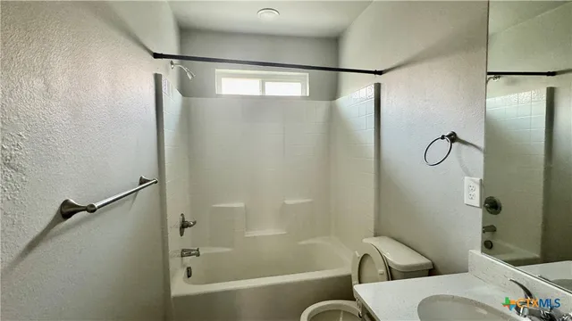 a bathroom with a glass shower and a toilet