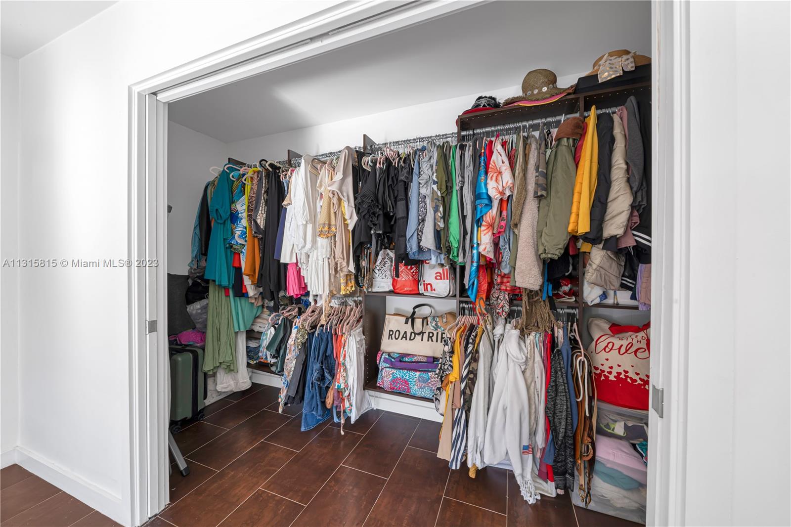 141 Southwest 24th Road Miami, FL 33129 - Photo 47 of 58 a view of walk in closet with clothes and shoes