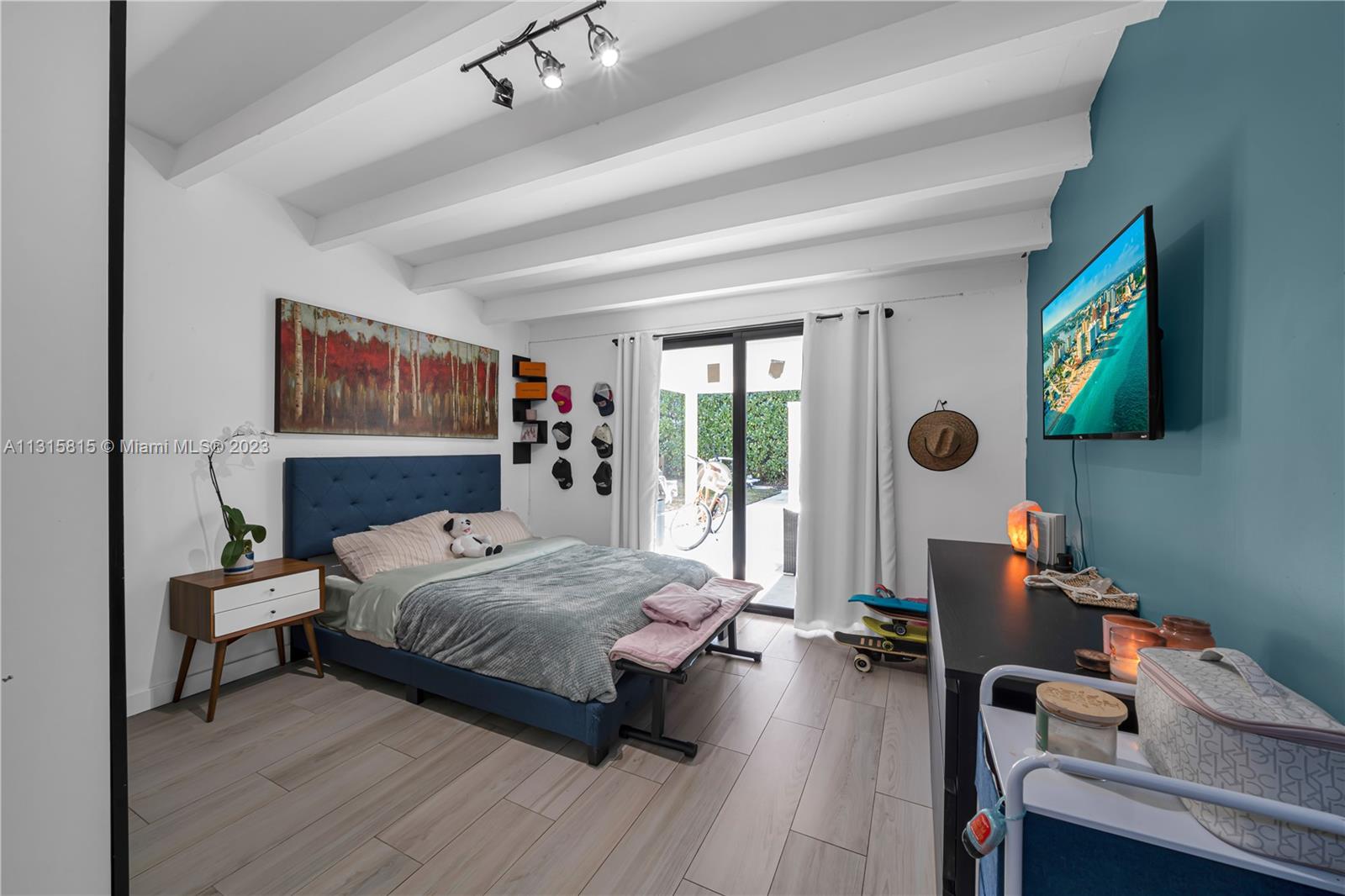 141 Southwest 24th Road Miami, FL 33129 - Photo 6 of 58 a bedroom with a bed and a flat screen tv