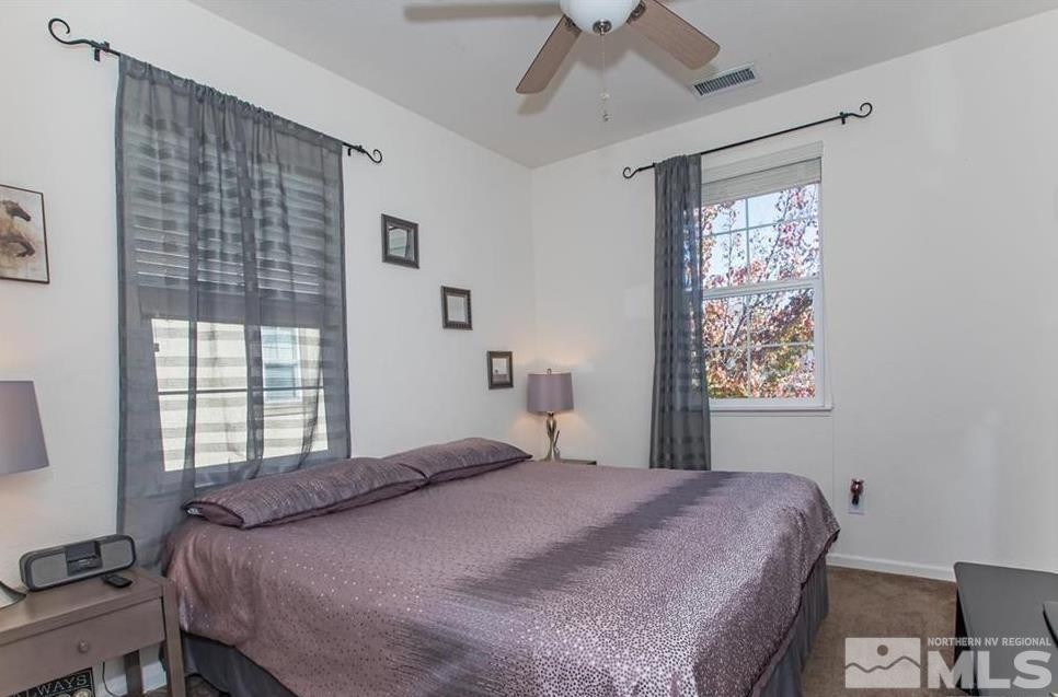 6923 Sacred Circle Sparks, NV 89436 - Photo 11 of 16 a bedroom with a bed and a window