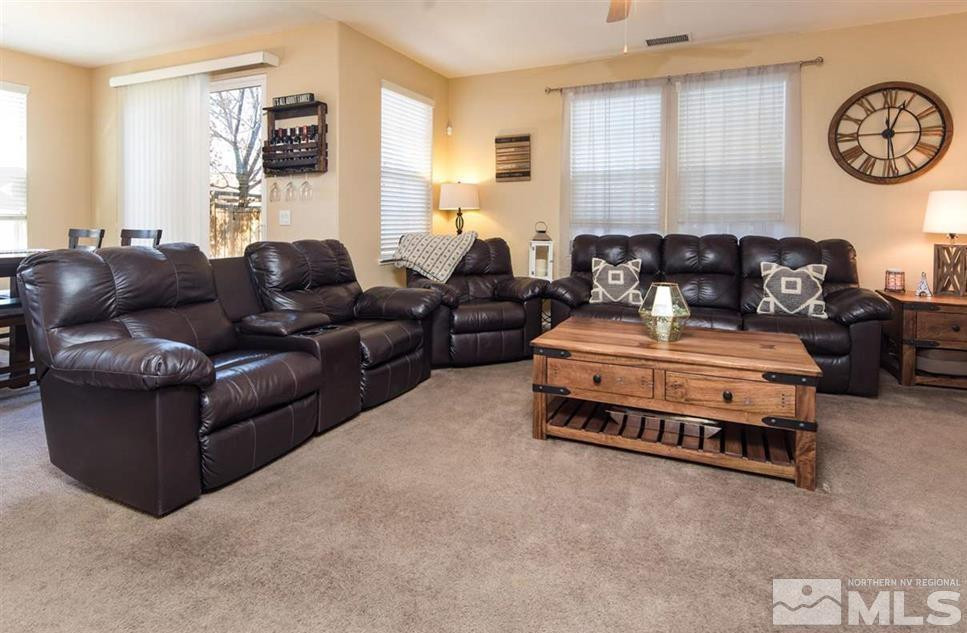 6923 Sacred Circle Sparks, NV 89436 - Photo 5 of 16 a living room with furniture a clock on wall and a window