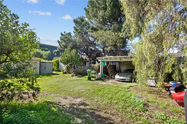 a backyard of a house with table and chairs