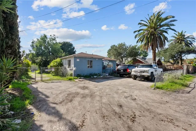 a view of a house with a yard and sitting area