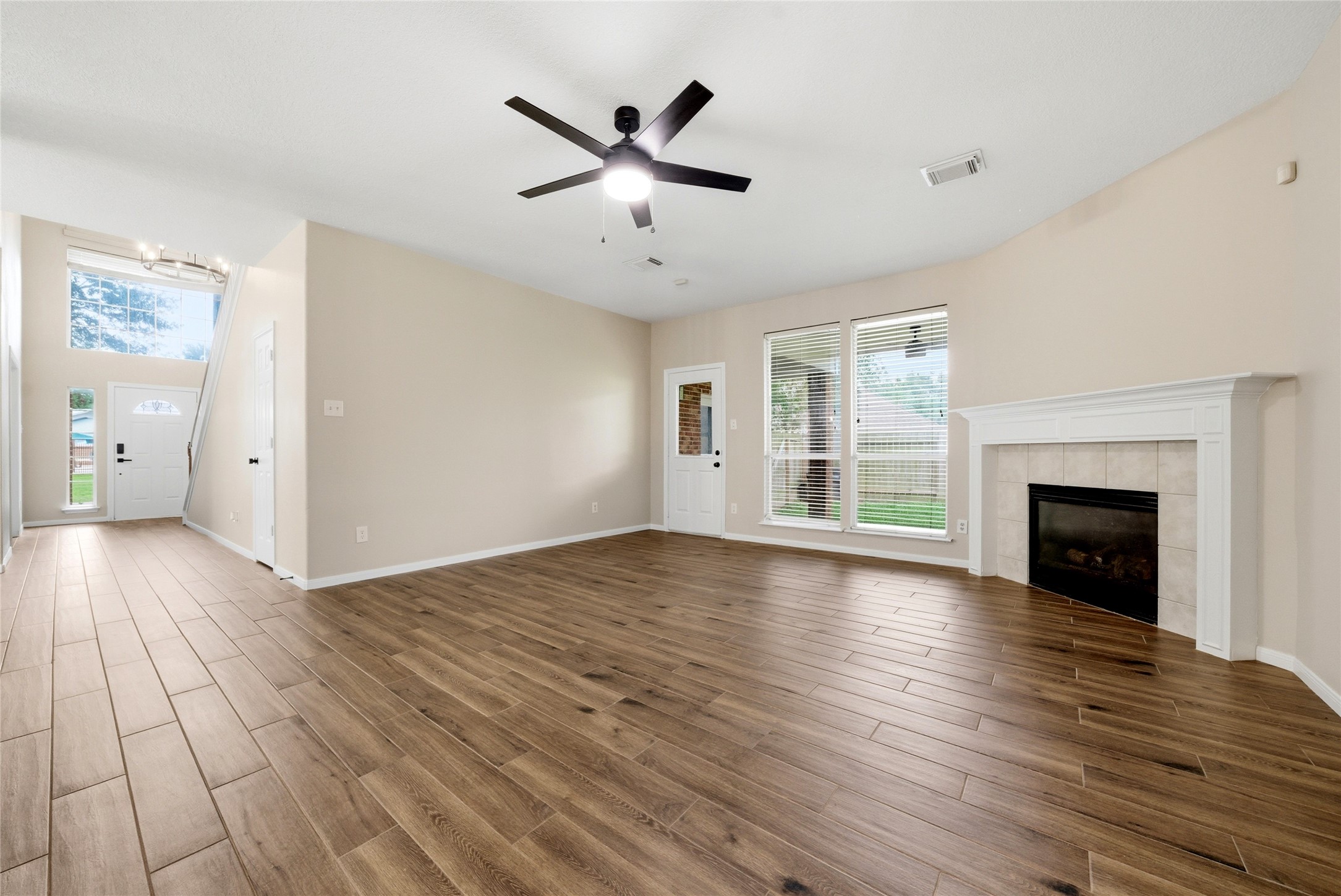 3711 Slocom Drive Katy, TX 77449 - Photo 20 of 46 a view of empty room with wooden floor and fireplace