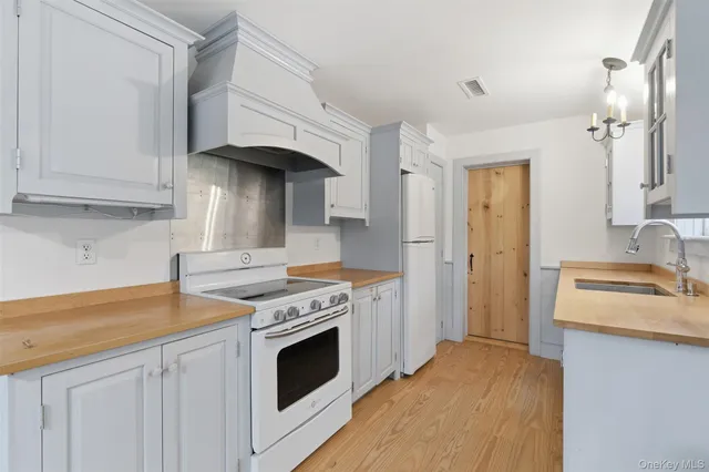 a kitchen with stainless steel appliances granite countertop a stove and a refrigerator