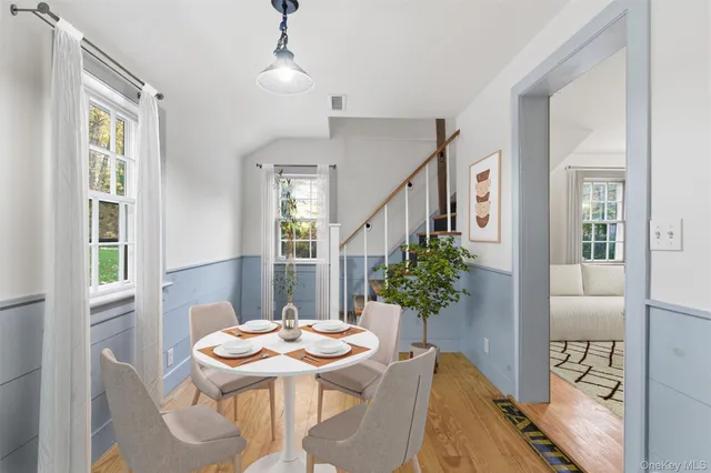 a view of a dining room with furniture and wooden floor