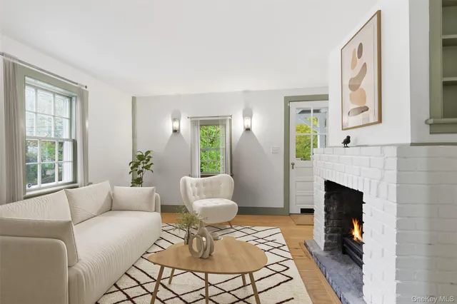 a living room with furniture a fireplace and a large window