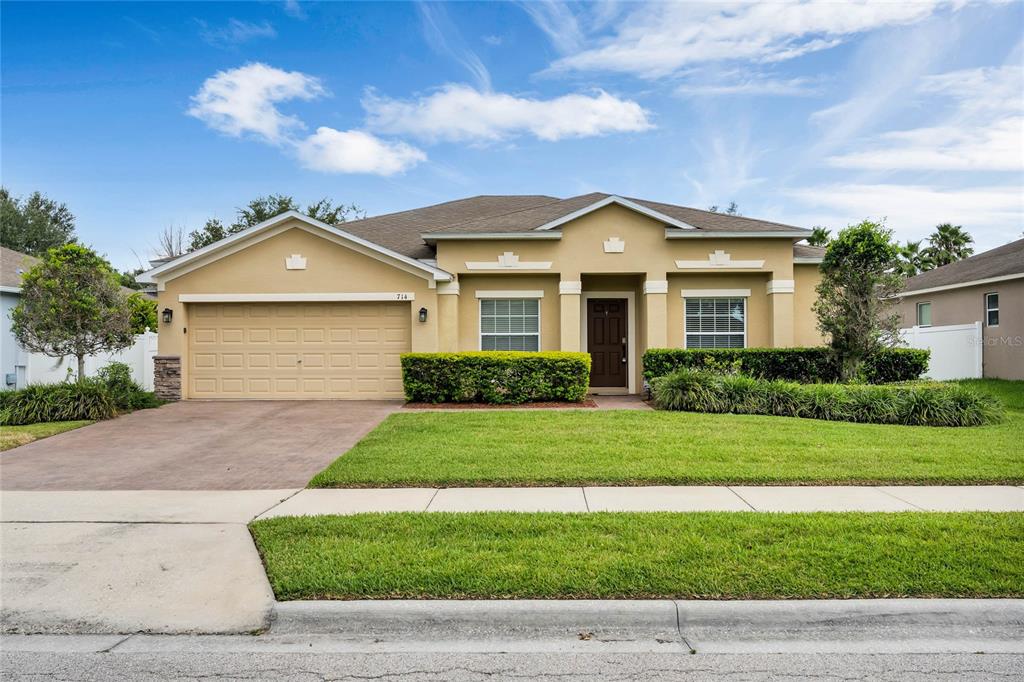a front view of a house with a yard
