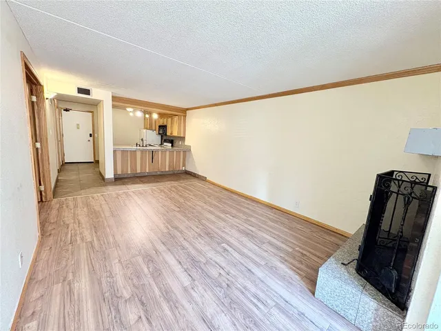 a view of a room with wooden floor and a sink