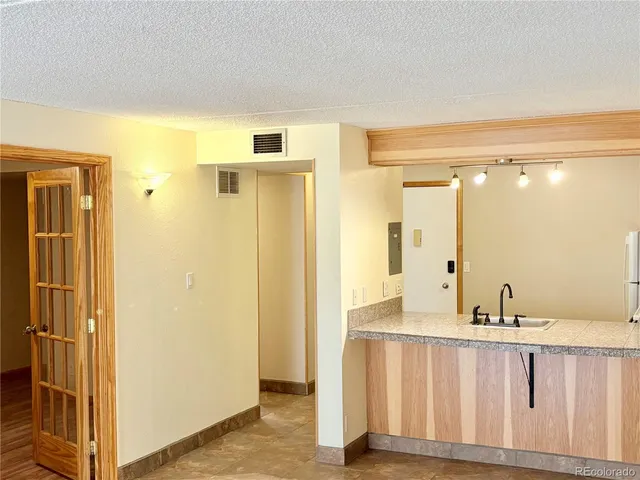 a bathroom with a shower a sink and a mirror