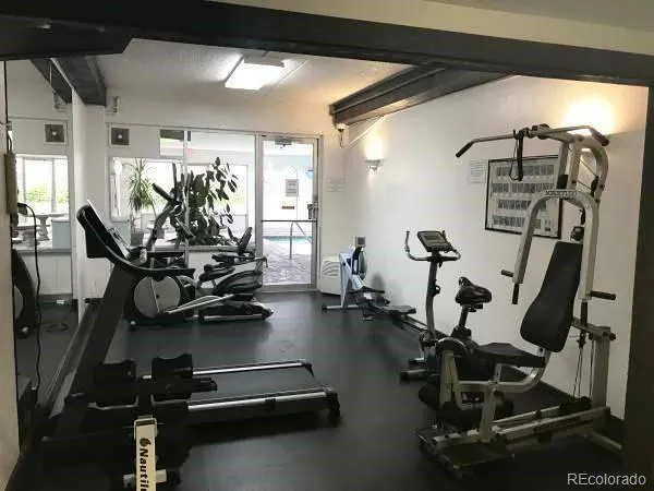 a room with gym equipment and windows