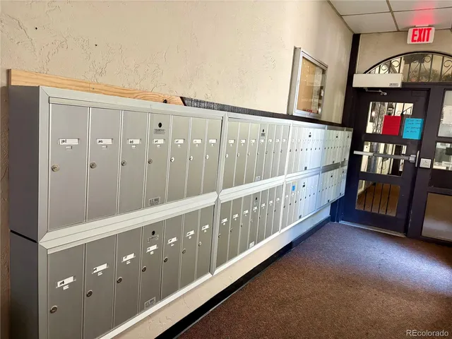 a view of staircase with lots of frames on wall and a window