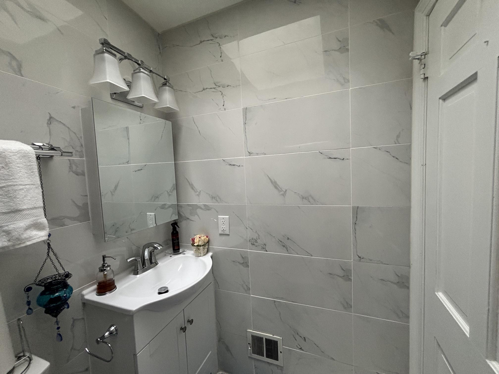 608 6th Place Southwest Washington, DC 20024 - Photo 52 of 65 Sleek modern bathroom, again with marble tiles.