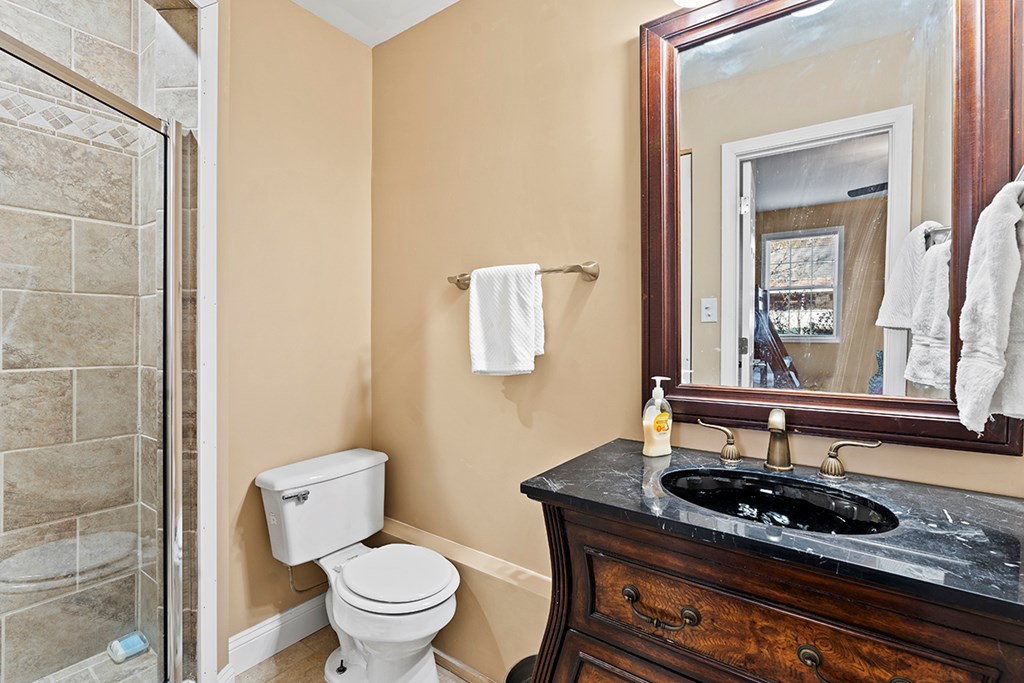 986 Ridgewood Harbor Road Waterloo, SC 29384 - Photo 17 of 43 a bathroom with a granite countertop sink and a mirror