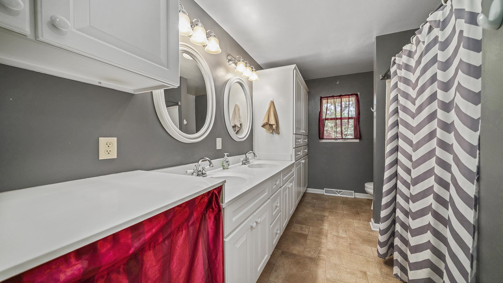 3691 South Bend Road Rockford, IL 61109 - Photo 16 of 34 a en suite bathroom with a granite countertop sink and a mirror