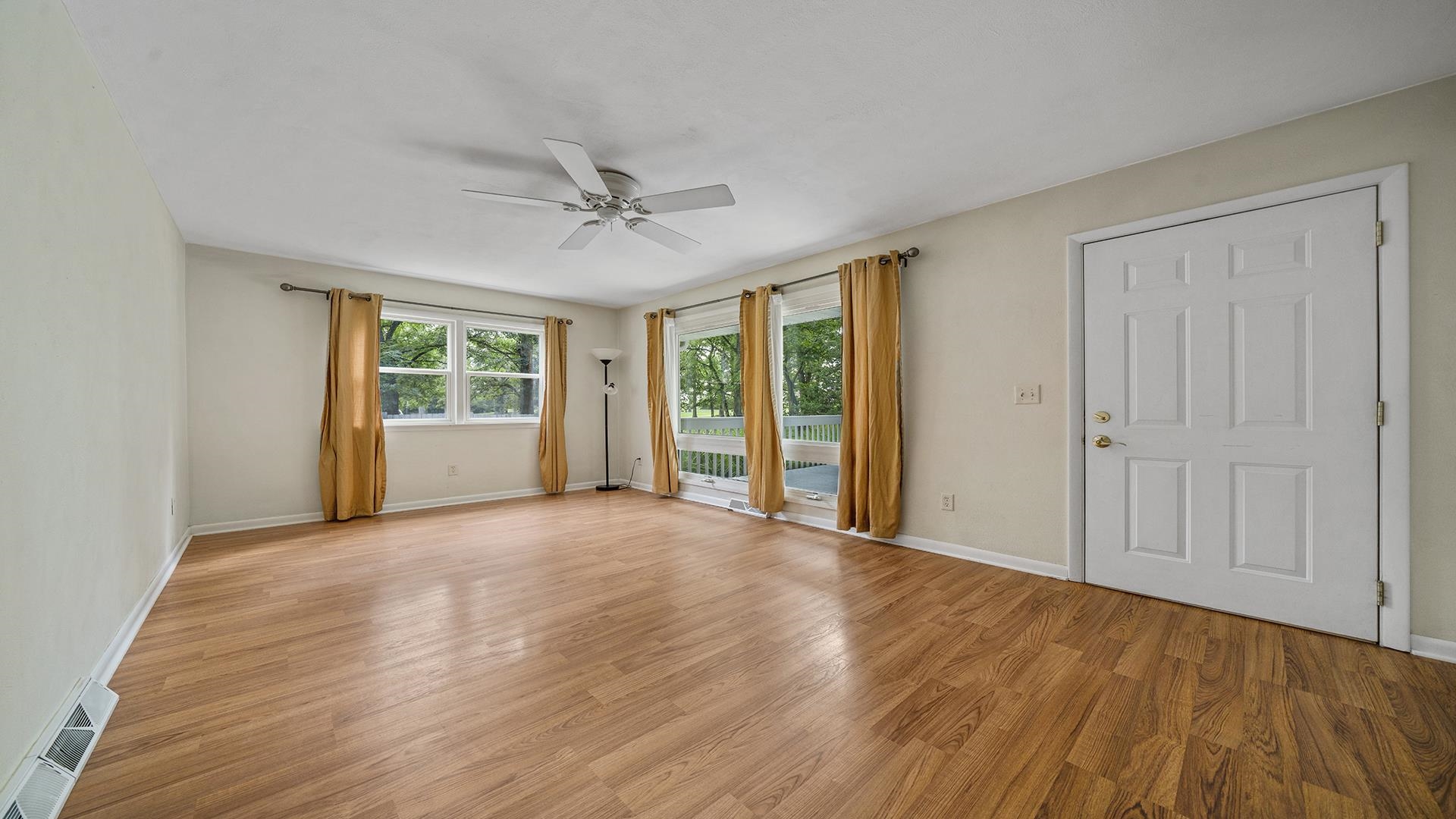 3691 South Bend Road Rockford, IL 61109 - Photo 2 of 34 a view of an empty room with a window and wooden floor