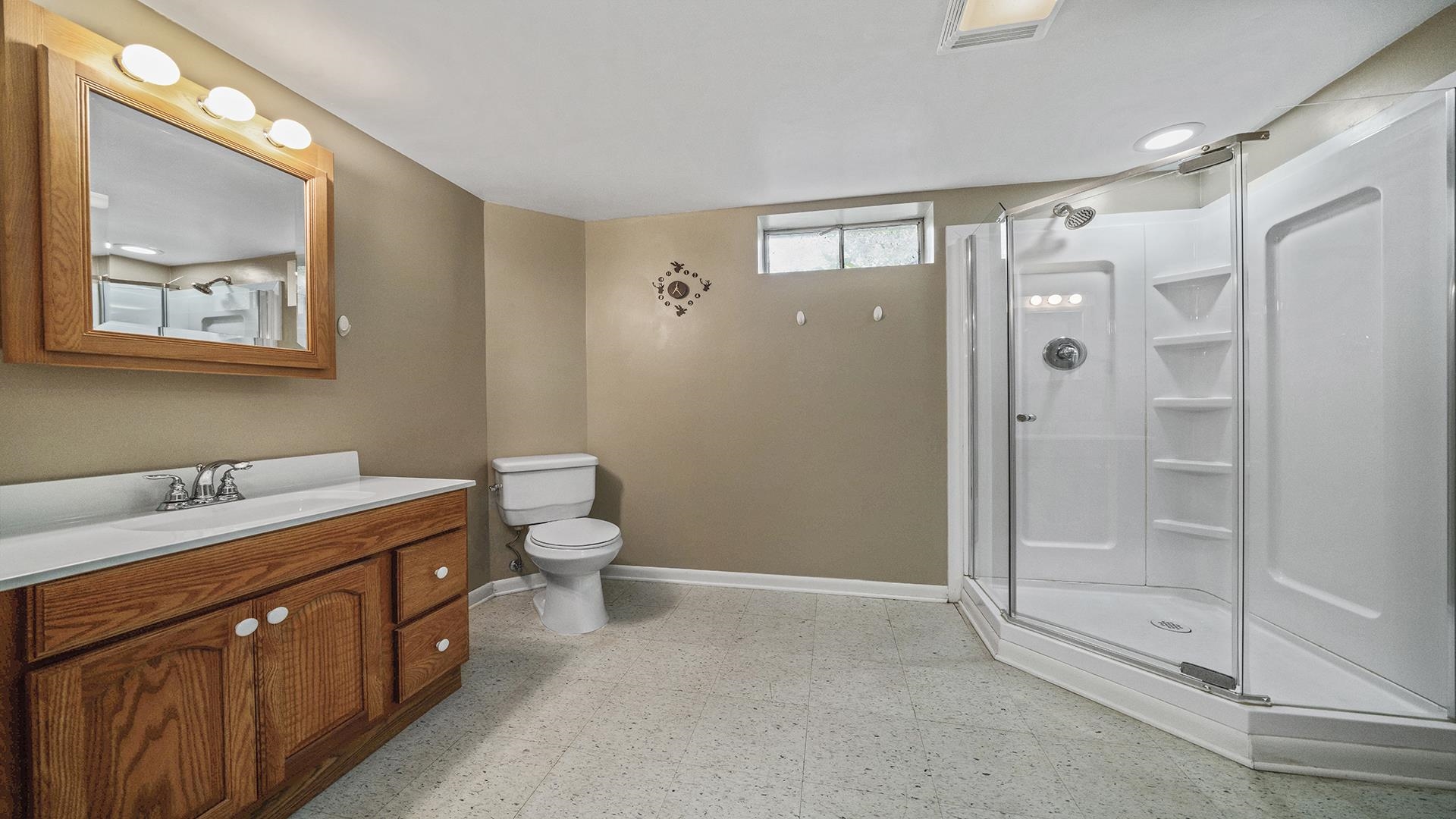 3691 South Bend Road Rockford, IL 61109 - Photo 25 of 34 a bathroom with a double vanity sink toilet and shower