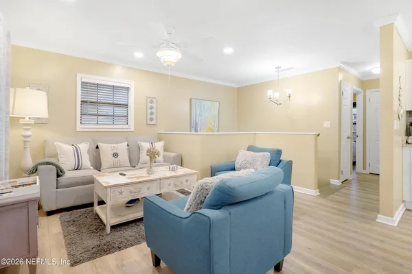 a living room with furniture and wooden floor