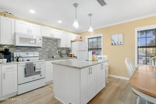 a kitchen with stainless steel appliances granite countertop a sink and cabinets