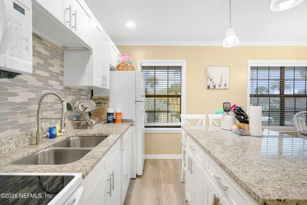 a kitchen with stainless steel appliances granite countertop a sink stove and cabinets