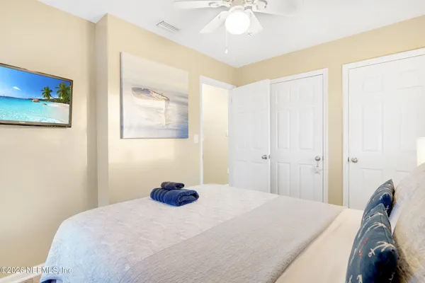 a bedroom with a bed and a chandelier