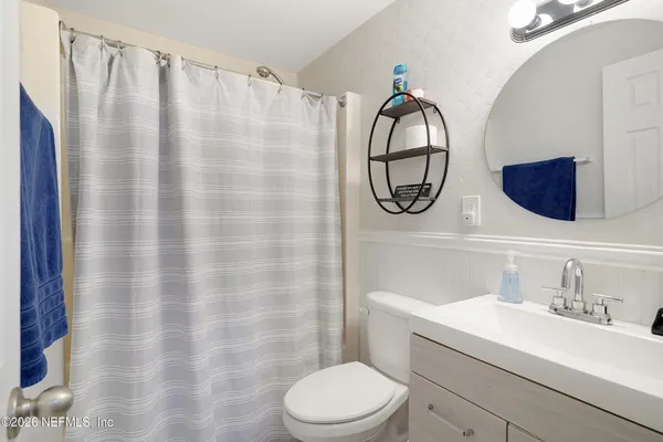 a bathroom with a sink toilet and a mirror